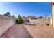 Gravel backyard featuring a decorative shrub and block perimeter wall with brick detail at 1444 Country Hollow Dr, Las Vegas, NV 89117