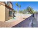 Concrete patio leads to a fire pit in the backyard, surrounded by a gravel ground cover at 1444 Country Hollow Dr, Las Vegas, NV 89117