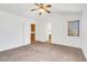 Bedroom featuring neutral carpet, a ceiling fan, and access to the bathroom at 1444 Country Hollow Dr, Las Vegas, NV 89117