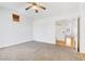 Spacious bedroom boasts vaulted ceiling, neutral carpet, and ceiling fan at 1444 Country Hollow Dr, Las Vegas, NV 89117