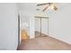 Neutral bedroom with beige carpet and mirrored closet doors provides ample storage space at 1444 Country Hollow Dr, Las Vegas, NV 89117