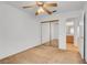 Bedroom with beige carpet and mirrored closet doors and ceiling fan at 1444 Country Hollow Dr, Las Vegas, NV 89117