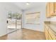 Bright breakfast nook features tile flooring, a window with blinds, and sliding glass door access to the yard at 1444 Country Hollow Dr, Las Vegas, NV 89117