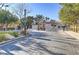 Gated community entrance with attractive stone pavers, landscaping, and decorative gates at 1444 Country Hollow Dr, Las Vegas, NV 89117