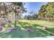 Lush community park with mature trees, green grass, and large boulders scattered throughout at 1444 Country Hollow Dr, Las Vegas, NV 89117