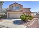 Two-story home featuring a tile roof, desert landscaping, and an attached two-car garage at 1444 Country Hollow Dr, Las Vegas, NV 89117