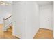 Hallway showcasing wood floors, white walls, doors, and partial view of a staircase at 1444 Country Hollow Dr, Las Vegas, NV 89117