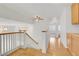 Bright upper hallway with wood floors, staircase with white banister and natural wood trim at 1444 Country Hollow Dr, Las Vegas, NV 89117