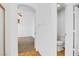 Neutral hallway with wood floors leading to a powder room and bedroom with ceiling fan at 1444 Country Hollow Dr, Las Vegas, NV 89117