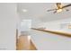 Upstairs hallway with a ceiling fan, hardwood flooring, and bright lighting at 1444 Country Hollow Dr, Las Vegas, NV 89117