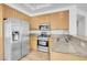 Kitchen featuring granite countertops, stainless steel appliances, and wood cabinets at 1444 Country Hollow Dr, Las Vegas, NV 89117