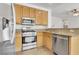 Bright kitchen featuring stainless steel appliances, granite countertops, and light-colored cabinetry at 1444 Country Hollow Dr, Las Vegas, NV 89117