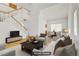 Bright, virtually staged living room with ample natural light and a modern staircase at 1444 Country Hollow Dr, Las Vegas, NV 89117