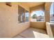 Covered front porch with stucco walls and shade from the desert sun at 1444 Country Hollow Dr, Las Vegas, NV 89117