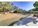 Paved walking path winds through the grassy community park with mature trees and landscaping at 1444 Country Hollow Dr, Las Vegas, NV 89117