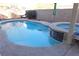 Backyard pool and jacuzzi featuring a waterfall and concrete surround at 180 Plumpjack Ave, Henderson, NV 89002