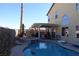 Backyard oasis with a large pool, hot tub, covered patio, and views of mountains at 180 Plumpjack Ave, Henderson, NV 89002