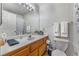 Clean bathroom with a functional vanity, a large mirror, and a toilet at 1800 Edmond St # 108, Las Vegas, NV 89146