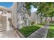 Townhouse exterior with tidy landscaping, stairs, and a sidewalk; street visible in background at 1800 Edmond St # 108, Las Vegas, NV 89146