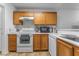 Well-lit kitchen featuring wooden cabinets, efficient appliances and a clean, bright space at 1800 Edmond St # 108, Las Vegas, NV 89146