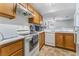 Functional kitchen with oak cabinetry, white appliances, and plenty of counter space at 1800 Edmond St # 108, Las Vegas, NV 89146