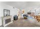 Inviting living room with fireplace, open-concept design, and views into the kitchen at 1800 Edmond St # 108, Las Vegas, NV 89146