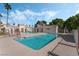 A community pool with crystal clear water is surrounded by lounging areas and lush landscaping at 1800 Edmond St # 108, Las Vegas, NV 89146