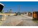 Backyard with gravel, shed, and wooden fence at 207 W Victory Rd, Henderson, NV 89015