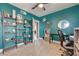 Stylish bedroom with teal walls, ceiling fan, and built-in workspace at 207 W Victory Rd, Henderson, NV 89015