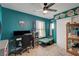 Functional bedroom with teal walls, ceiling fan, and built-in workspace at 207 W Victory Rd, Henderson, NV 89015