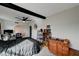 Cozy bedroom with ceiling fan, large window, and wooden dresser at 207 W Victory Rd, Henderson, NV 89015