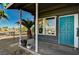 Inviting front porch with teal door and potted plants, offering a relaxing entryway at 207 W Victory Rd, Henderson, NV 89015