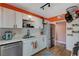 Modern kitchen with white cabinets and orange accent wall at 207 W Victory Rd, Henderson, NV 89015