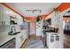 Modern kitchen with white cabinets and orange accent wall at 207 W Victory Rd, Henderson, NV 89015