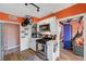 Modern kitchen with white cabinets and orange accent wall at 207 W Victory Rd, Henderson, NV 89015