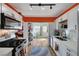 Modern kitchen with white cabinets and orange accent wall at 207 W Victory Rd, Henderson, NV 89015