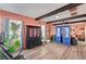 Living area with coral walls, hardwood floors, and a cat tree and exercise equipment at 207 W Victory Rd, Henderson, NV 89015