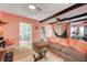 Bright living room with L-shaped sofa and exposed beams at 207 W Victory Rd, Henderson, NV 89015