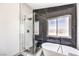 Modern bathroom features a shower with glass enclosure and a soaking tub near a window at 2133 Linden Tree St, Las Vegas, NV 89156