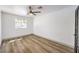 Inviting bedroom with light-colored floors, a ceiling fan, and a bright window providing ample natural light at 2133 Linden Tree St, Las Vegas, NV 89156