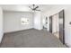 Spacious carpeted bedroom with ceiling fan, a window, and door to the ensuite bathroom at 2133 Linden Tree St, Las Vegas, NV 89156