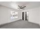 This bedroom features carpeting, a ceiling fan and an ensuite bathroom at 2133 Linden Tree St, Las Vegas, NV 89156