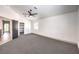 This carpeted bedroom features a ceiling fan and an open door to an attached closet at 2133 Linden Tree St, Las Vegas, NV 89156