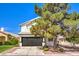 Inviting two-story home showcasing well-manicured landscaping and a two-car garage under a clear blue sky at 2133 Linden Tree St, Las Vegas, NV 89156