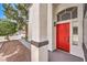 Welcoming front entrance with a vibrant red door, stylish exterior lighting, and attractive landscaping at 2133 Linden Tree St, Las Vegas, NV 89156