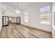 Spacious living room with stylish flooring, a modern chandelier, and ample natural light from numerous windows at 2133 Linden Tree St, Las Vegas, NV 89156