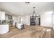 Spacious living room features laminate floors, a kitchen with an island, and a fireplace at 2133 Linden Tree St, Las Vegas, NV 89156