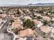 Community shot showcasing desert landscaping, tile roofs, and mountain views in the distance at 2153 Hookcross Cir, Henderson, NV 89074