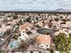 Expansive aerial view of a desert neighborhood with terracotta roofs, mature landscaping, and mountain views at 2153 Hookcross Cir, Henderson, NV 89074