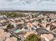 Scenic aerial of a desert neighborhood featuring terra-cotta roofs, mature trees, and mountain range backdrop at 2153 Hookcross Cir, Henderson, NV 89074